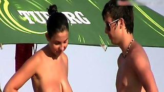 Busty topless brunette on the beach with douchebag